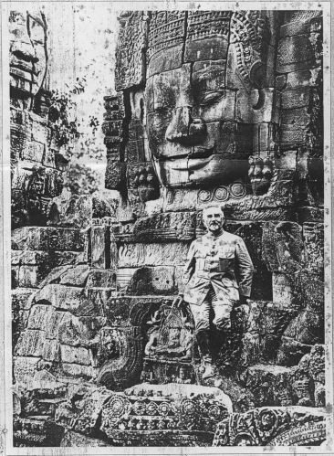Black and white photograph of Finot in front of the Bayon temple in Angkor