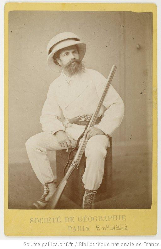 Photograph of a man in colonial uniform holding a rifle