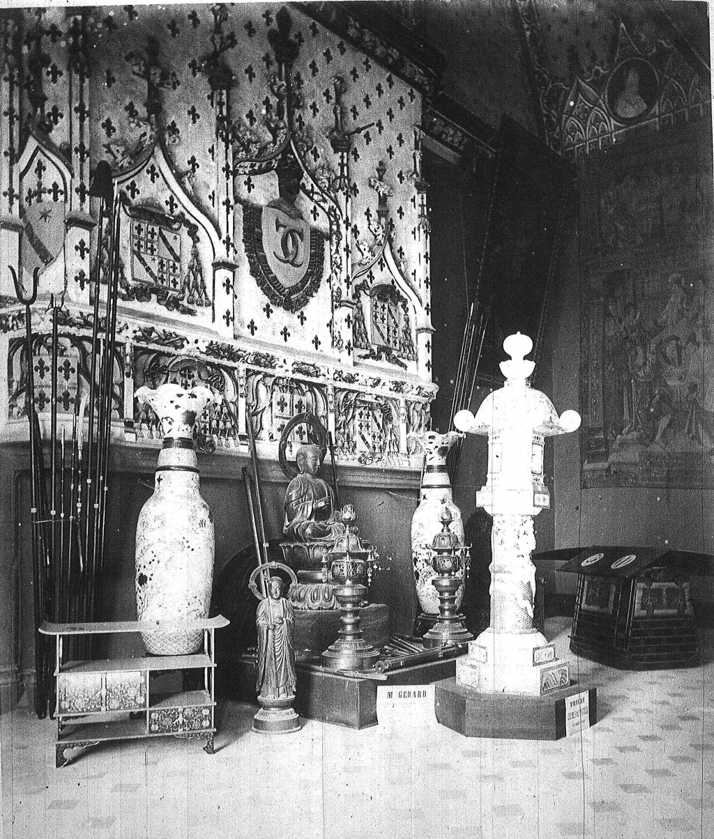 Black and white photograph of an interior decorated with Asian objects.