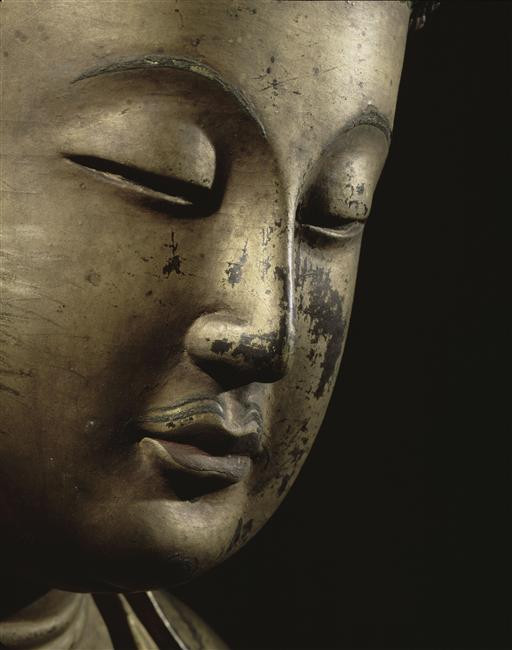 Photograph of the face of a Buddha sculpture